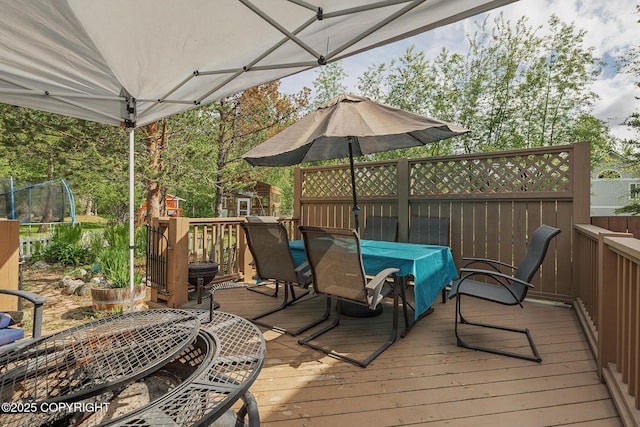1061 E Agate Ln, Wasilla, AK 99654 - wooden terrace with a trampoline and outdoor dining area