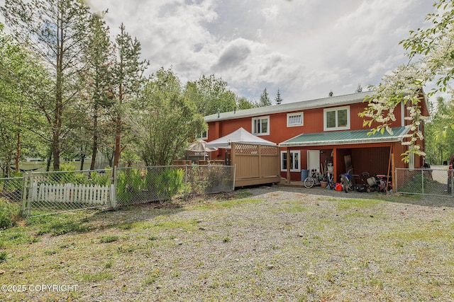 1061 E Agate Ln, Wasilla, AK 99654 - rear view of house with a fenced backyard