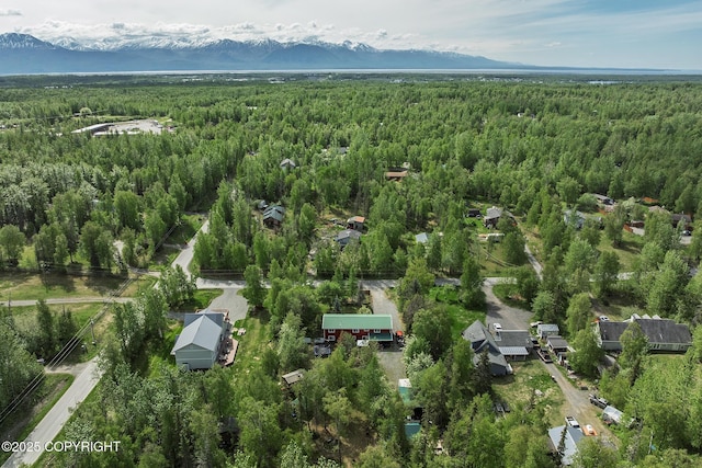 1061 E Agate Ln, Wasilla, AK 99654 - aerial view of property and surrounding area with a heavily wooded area and a mountain backdrop