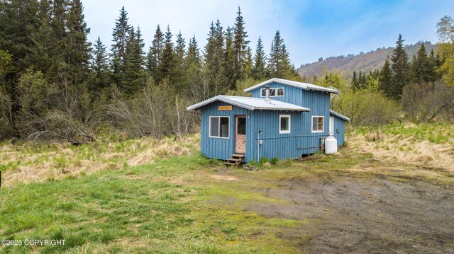 55851 Glenn Rd, Homer, AK 99603 - view of outdoor structure featuring a forest view