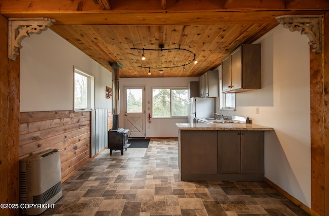 55851 Glenn Rd, Homer, AK 99603 - kitchen with a wood stove, wood ceiling, baseboards, freestanding refrigerator, and a peninsula
