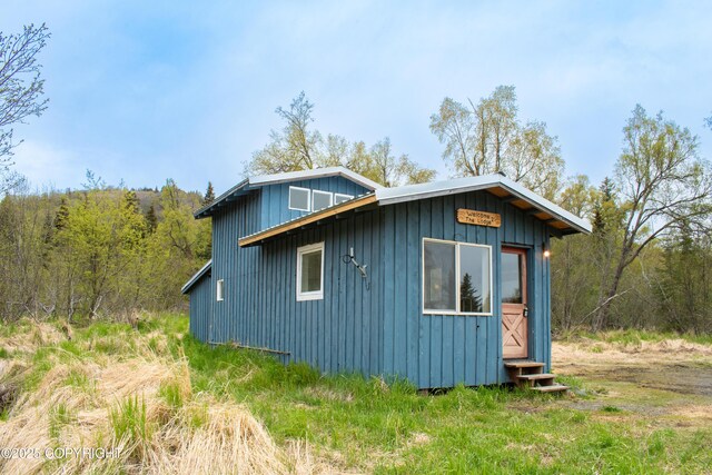 55851 Glenn Rd, Homer, AK 99603 - view of side of property with board and batten siding, entry steps, and a wooded view