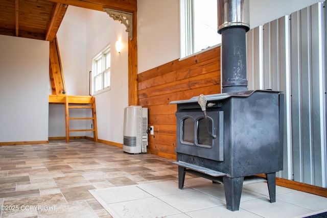 55851 Glenn Rd, Homer, AK 99603 - unfurnished living room featuring a wood stove, wood ceiling, and baseboards