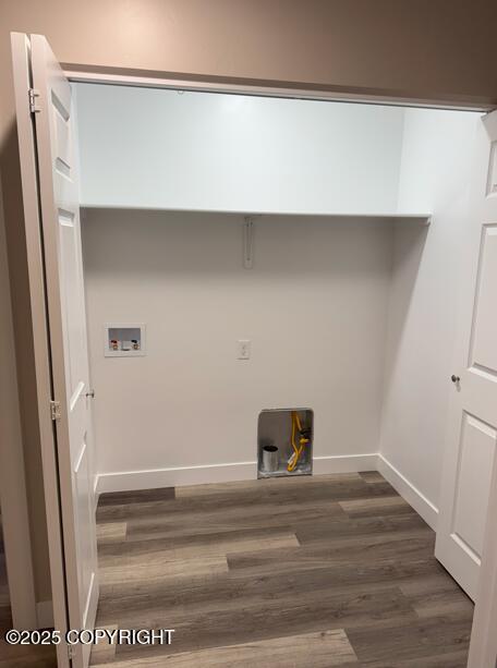 laundry area with wood finished floors, baseboards, and hookup for a washing machine