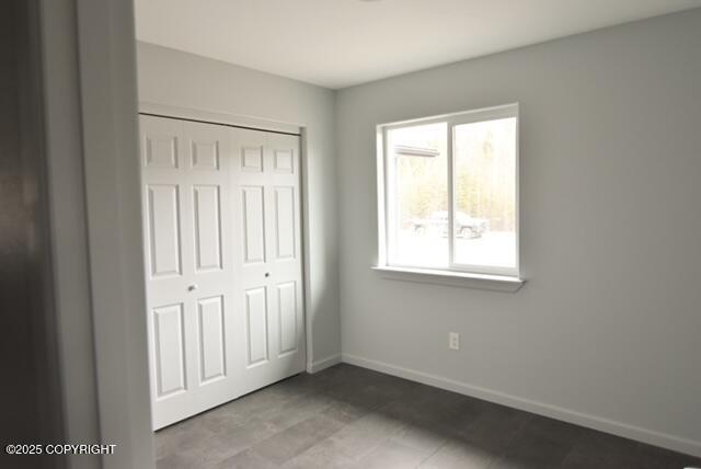 41485 Derks Lake Rd, Soldotna, AK 99669 - unfurnished bedroom featuring a closet and baseboards