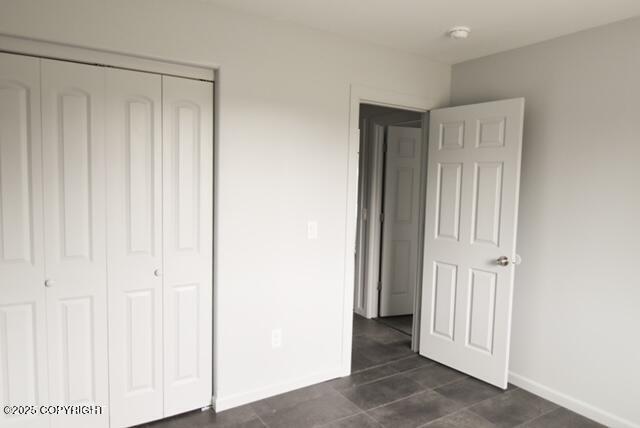 41485 Derks Lake Rd, Soldotna, AK 99669 - unfurnished bedroom featuring a closet and baseboards