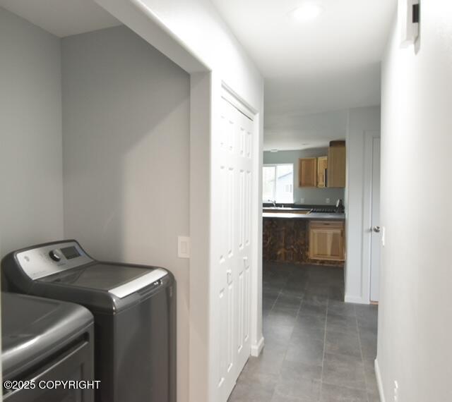 41485 Derks Lake Rd, Soldotna, AK 99669 - clothes washing area with washer and dryer, dark tile patterned floors, and baseboards