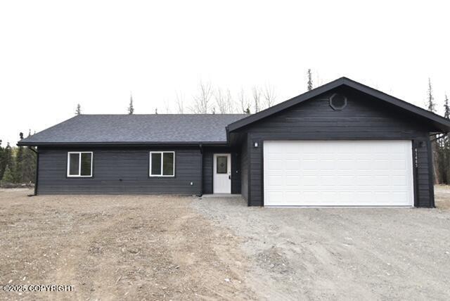 41485 Derks Lake Rd, Soldotna, AK 99669 - ranch-style home with dirt driveway and a garage