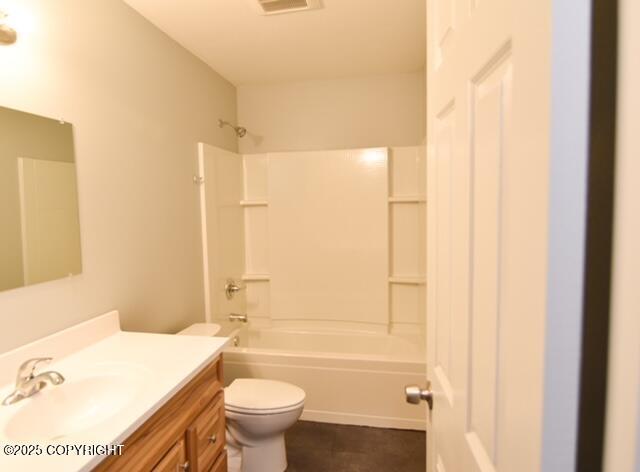 41485 Derks Lake Rd, Soldotna, AK 99669 - bathroom with toilet, vanity, bathtub / shower combination, and tile patterned flooring