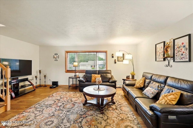 664 E Auklet Ave, Palmer, AK 99645 - living room with wood finished floors, a textured ceiling, and baseboard heating