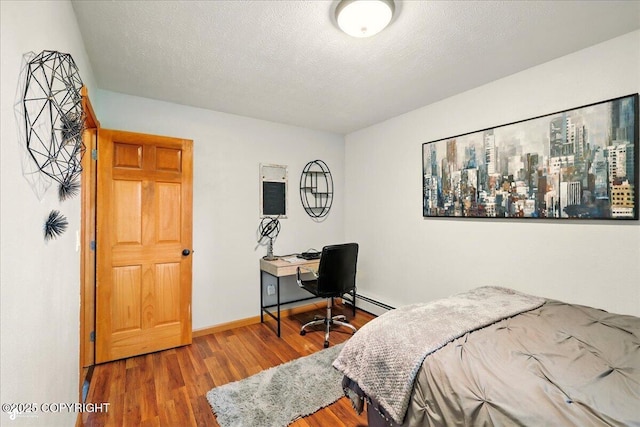 664 E Auklet Ave, Palmer, AK 99645 - bedroom featuring wood finished floors, a desk, and baseboards