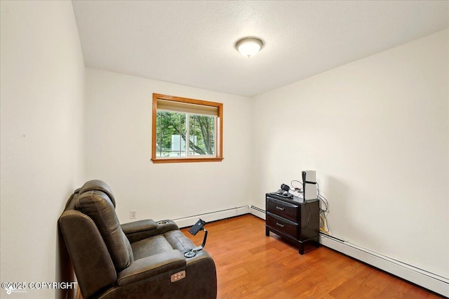 664 E Auklet Ave, Palmer, AK 99645 - sitting room featuring a baseboard heating unit and light wood-type flooring