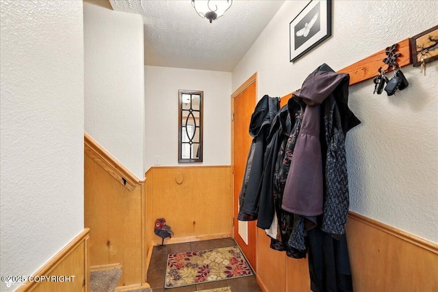 664 E Auklet Ave, Palmer, AK 99645 - doorway featuring wainscoting, a textured ceiling, wooden walls, and a textured wall