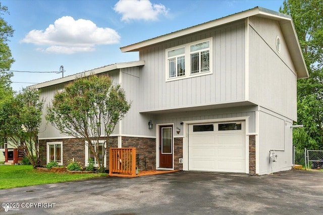 664 E Auklet Ave, Palmer, AK 99645 - view of front of property with stone siding, an attached garage, and asphalt driveway