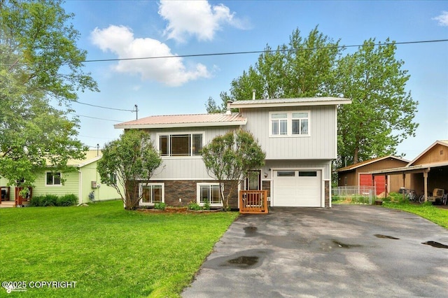 664 E Auklet Ave, Palmer, AK 99645 - view of front of home featuring driveway, an attached garage, stone siding, and metal roof