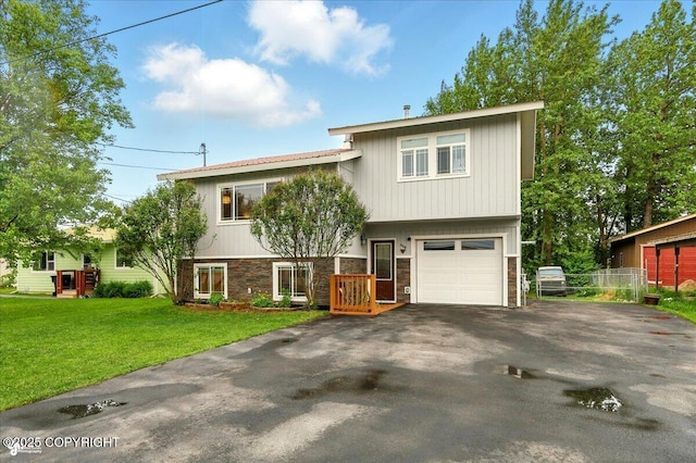 664 E Auklet Ave, Palmer, AK 99645 - view of front facade featuring driveway, stone siding, and a garage