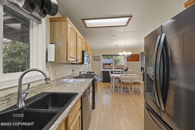 9224 Geese Cir, Eagle River, AK 99577 - kitchen featuring stainless steel appliances, a sink, light wood finished floors, a chandelier, and light stone counters