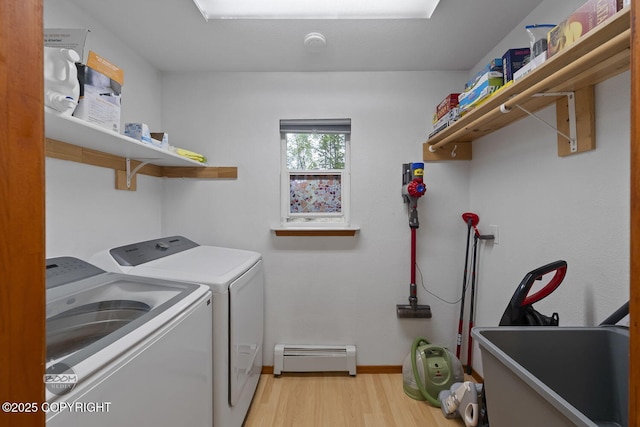 9224 Geese Cir, Eagle River, AK 99577 - laundry room with washing machine and dryer, a baseboard radiator, light wood-style floors, and baseboards