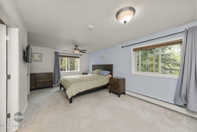 9224 Geese Cir, Eagle River, AK 99577 - bedroom with light carpet, a baseboard radiator, ceiling fan, and baseboards