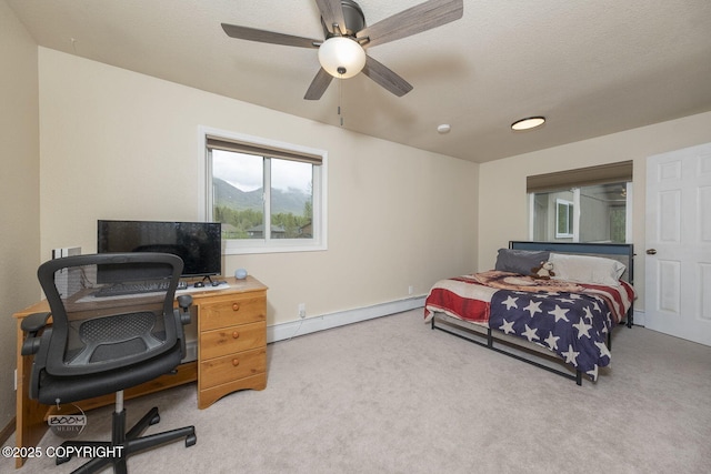 9224 Geese Cir, Eagle River, AK 99577 - bedroom featuring a baseboard radiator, carpet, an office area, a ceiling fan, and baseboards