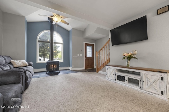 9224 Geese Cir, Eagle River, AK 99577 - carpeted living area with a wood stove, vaulted ceiling, stairs, baseboards, and ceiling fan