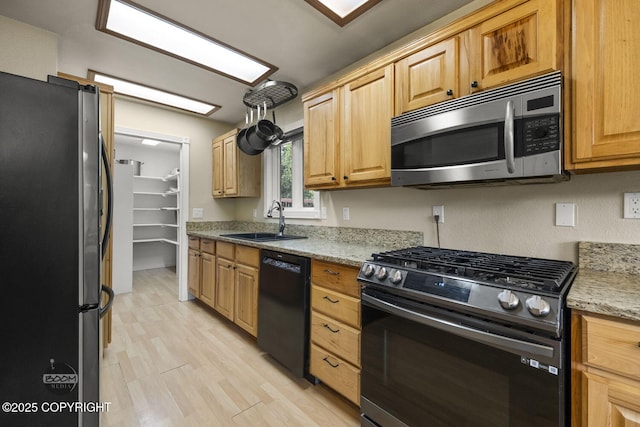 9224 Geese Cir, Eagle River, AK 99577 - kitchen featuring stainless steel appliances, a sink, light wood-type flooring, and light stone countertops