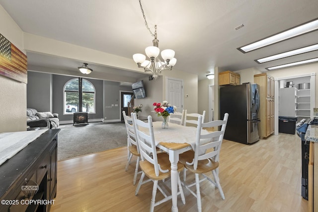 9224 Geese Cir, Eagle River, AK 99577 - dining space with a chandelier and light wood-type flooring
