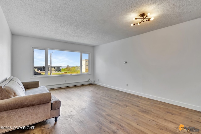 832 O Pl Unit 832, Anchorage, AK 99501 - living area with a baseboard heating unit, wood finished floors, a textured ceiling, and baseboards