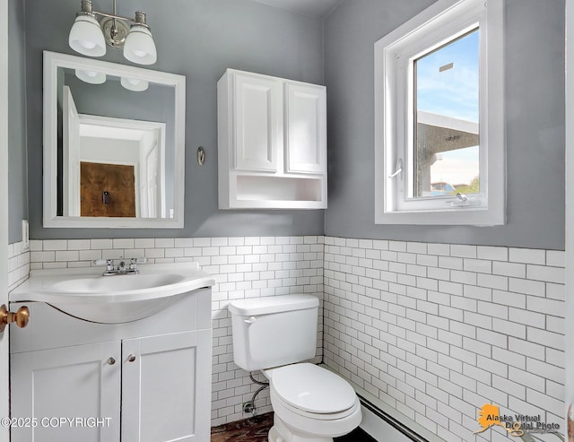 832 O Pl Unit 832, Anchorage, AK 99501 - half bathroom with tile walls, vanity, toilet, and wainscoting