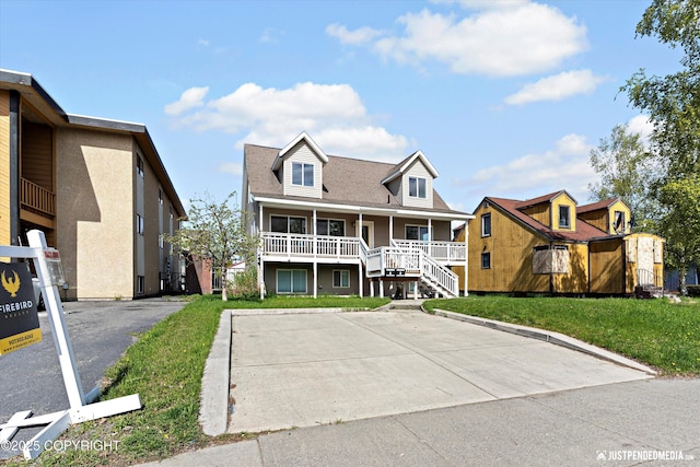 437 E 14th Ave, Anchorage, AK 99501 - view of front of home with covered porch, a front yard, and stairs