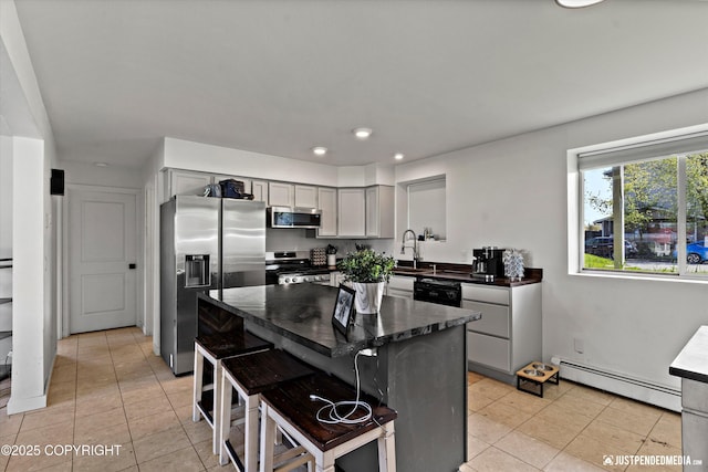 437 E 14th Ave, Anchorage, AK 99501 - kitchen with a baseboard radiator, stainless steel appliances, dark countertops, gray cabinetry, and light tile patterned flooring