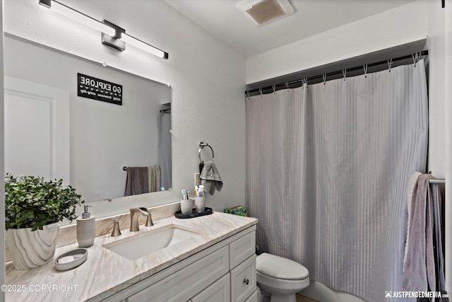 437 E 14th Ave, Anchorage, AK 99501 - full bath with toilet, vanity, and a textured wall