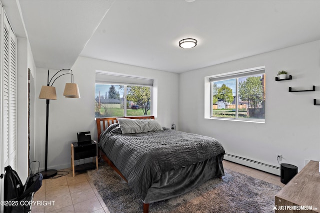 437 E 14th Ave, Anchorage, AK 99501 - bedroom featuring baseboard heating, light tile patterned floors, multiple windows, and baseboards