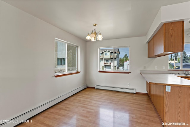 437 E 14th Ave, Anchorage, AK 99501 - unfurnished dining area featuring a baseboard radiator, baseboard heating, a chandelier, and light wood-style floors