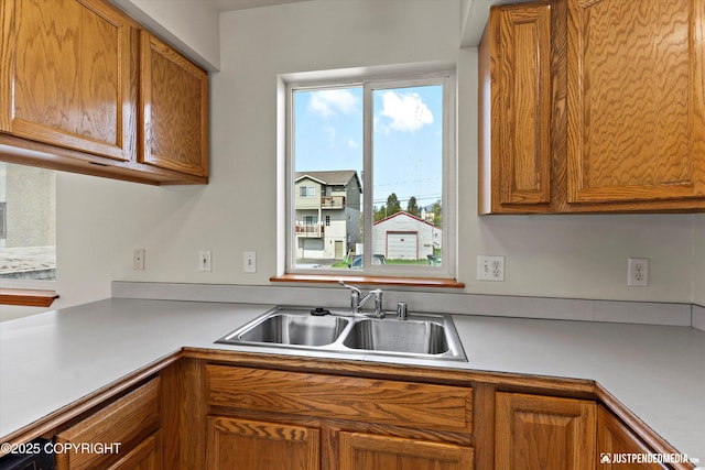 437 E 14th Ave, Anchorage, AK 99501 - kitchen featuring a sink, brown cabinetry, and light countertops