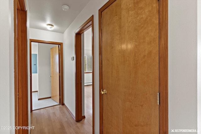 437 E 14th Ave, Anchorage, AK 99501 - hallway with a baseboard heating unit, light wood-type flooring, and baseboards