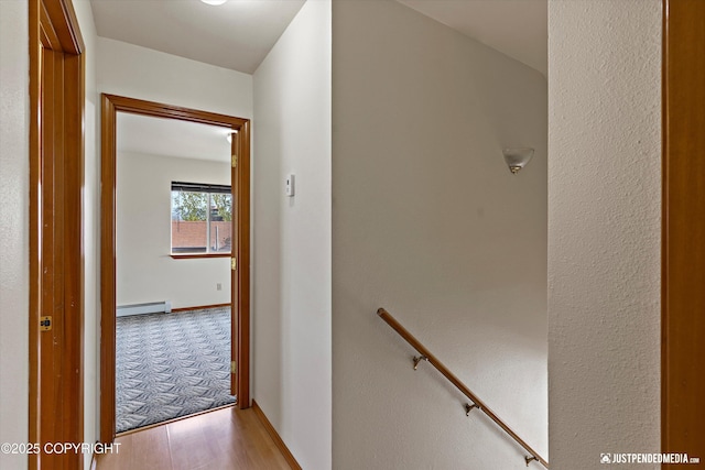 437 E 14th Ave, Anchorage, AK 99501 - hall featuring baseboard heating, light wood-style floors, and an upstairs landing