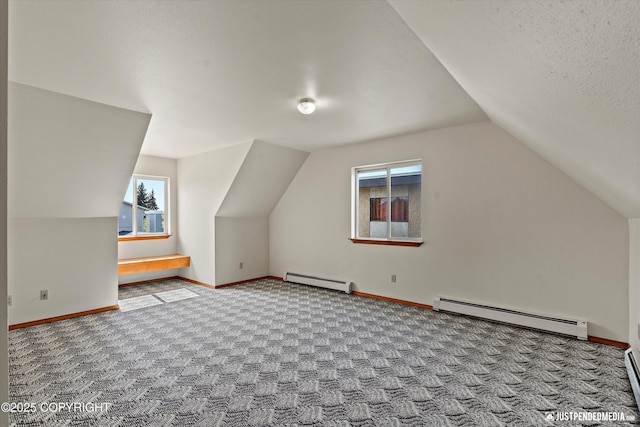 437 E 14th Ave, Anchorage, AK 99501 - additional living space with a baseboard radiator, plenty of natural light, carpet, and lofted ceiling