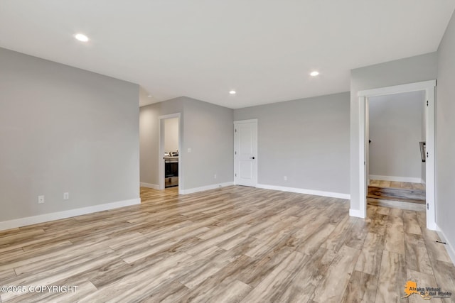 6033 Heather Wood Cir, Anchorage, AK 99502 - spare room featuring light wood-style flooring, baseboards, and recessed lighting