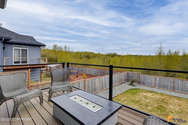 6033 Heather Wood Cir, Anchorage, AK 99502 - wooden terrace with a fire pit, a fenced backyard, and a view of trees