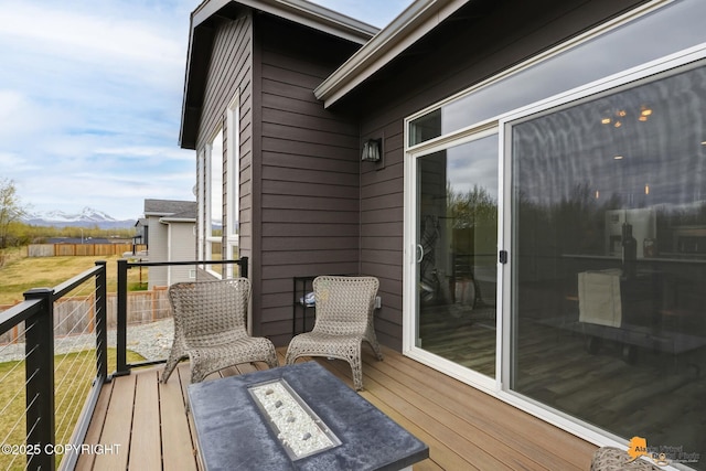 6033 Heather Wood Cir, Anchorage, AK 99502 - view of wooden balcony with a deck and a fire pit