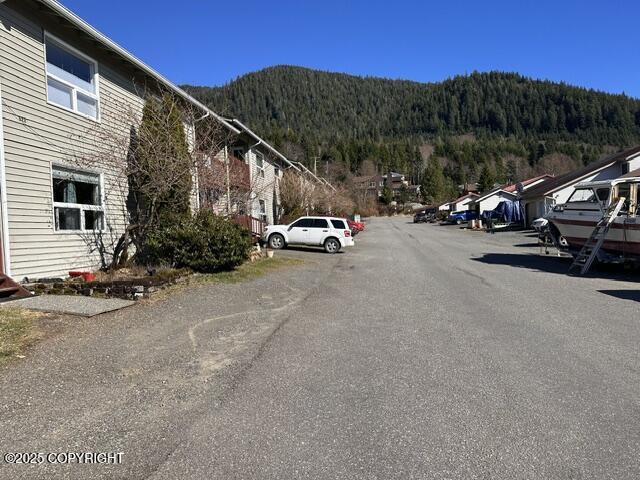 3220 Timberline Ct # 206, Ketchikan, AK 99901 - view of asphalt street featuring a mountain view and a wooded view