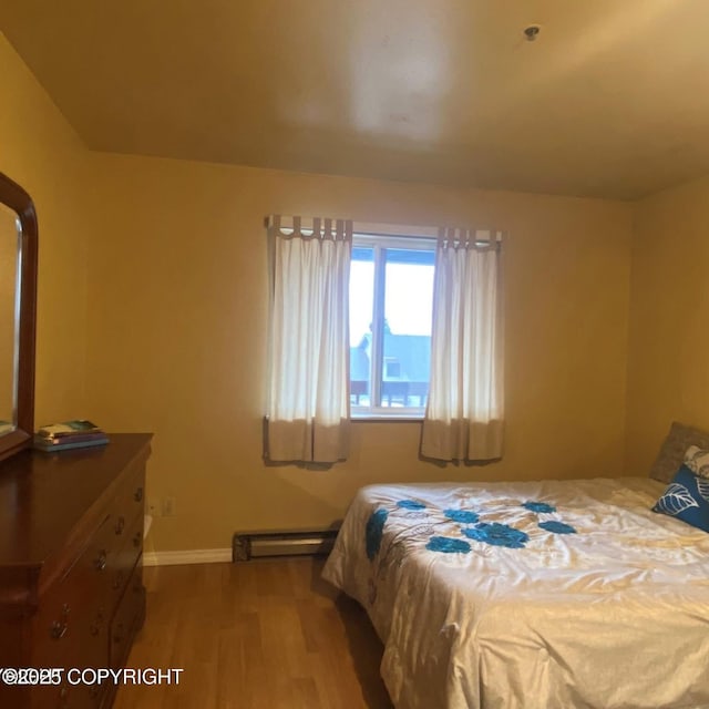3220 Timberline Ct # 206, Ketchikan, AK 99901 - bedroom with wood finished floors, baseboard heating, and baseboards