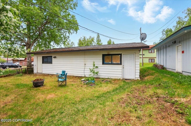 4109 Garfield St, Anchorage, AK 99503 - rear view of property featuring a fire pit and a lawn