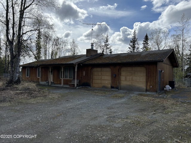 315 On Par Ln, Soldotna, AK 99669 - view of front of property with a chimney, dirt driveway, and covered porch