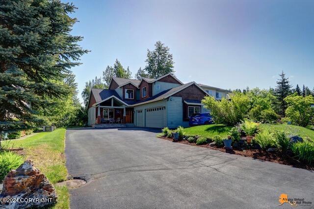 2923 Captain Cook Estates Cir, Anchorage, AK 99517 - view of front of home with an attached garage, driveway, and a front lawn