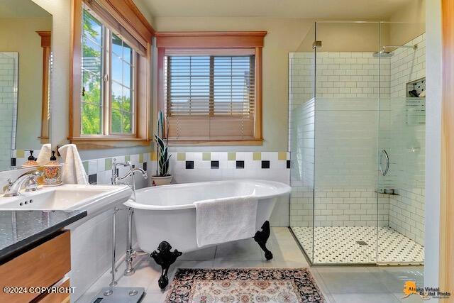 2923 Captain Cook Estates Cir, Anchorage, AK 99517 - full bathroom featuring a stall shower, vanity, a freestanding bath, and tile patterned floors