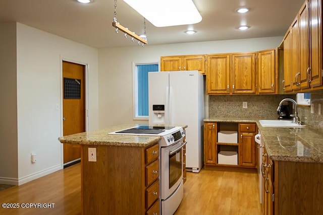 19404 Middleton Loop, Eagle River, AK 99577 - kitchen featuring white appliances, a sink, light wood finished floors, brown cabinetry, and recessed lighting