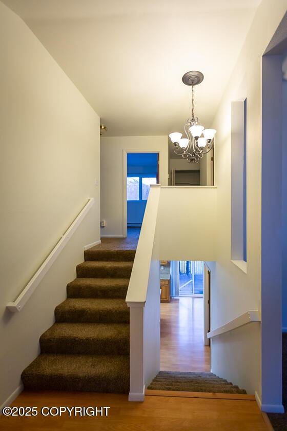 19404 Middleton Loop, Eagle River, AK 99577 - stairs with wood finished floors, a chandelier, and baseboards