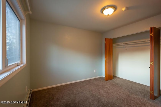 19404 Middleton Loop, Eagle River, AK 99577 - unfurnished bedroom featuring carpet, a closet, baseboard heating, and baseboards